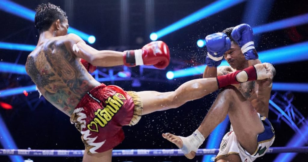 A Muay Thai kick blocked by the knee and arms.