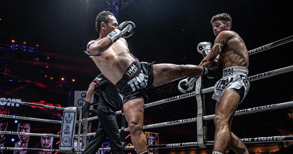 Two Muay Thai fighters engaged in combat