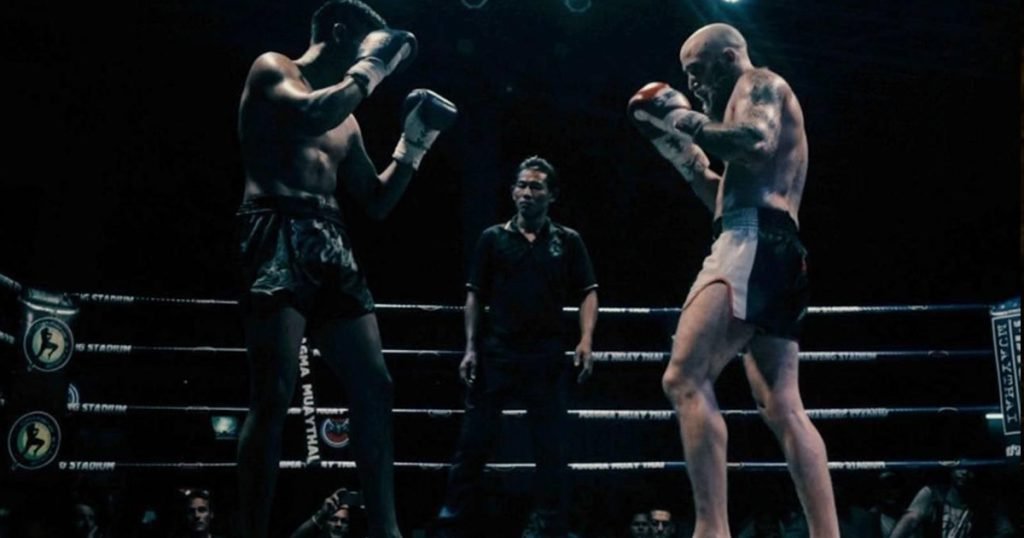 Two Muay Thai fighters standing in a fighting ring